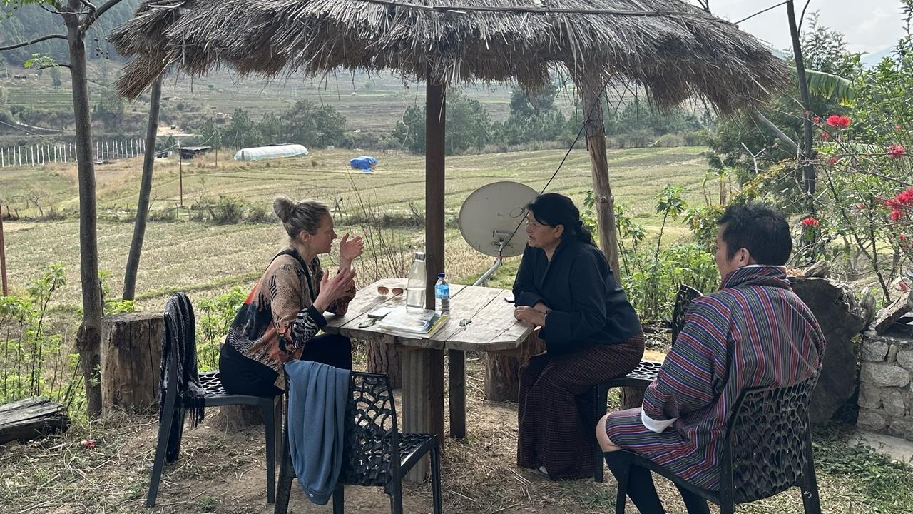 People chatting under a sin shade in rural Bhutan