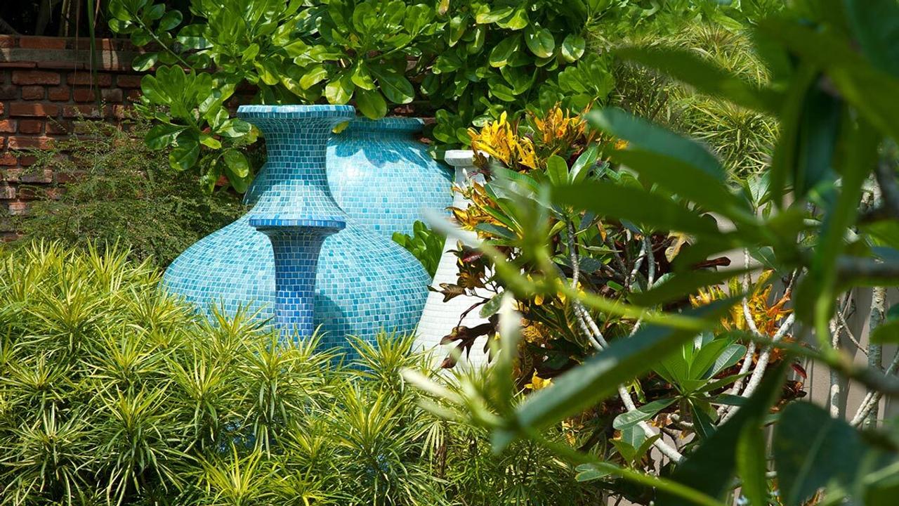 Large blue tiled urn in a garden