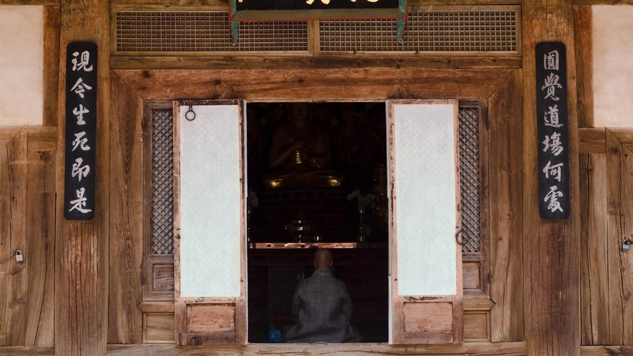 Monk meditating in temple, South Korea