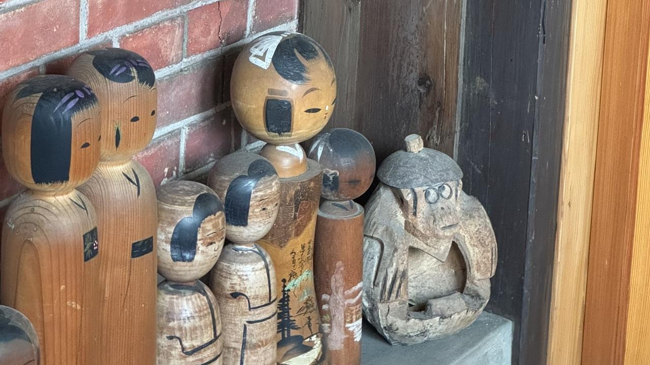 Small wooden statues on a shelf Japan