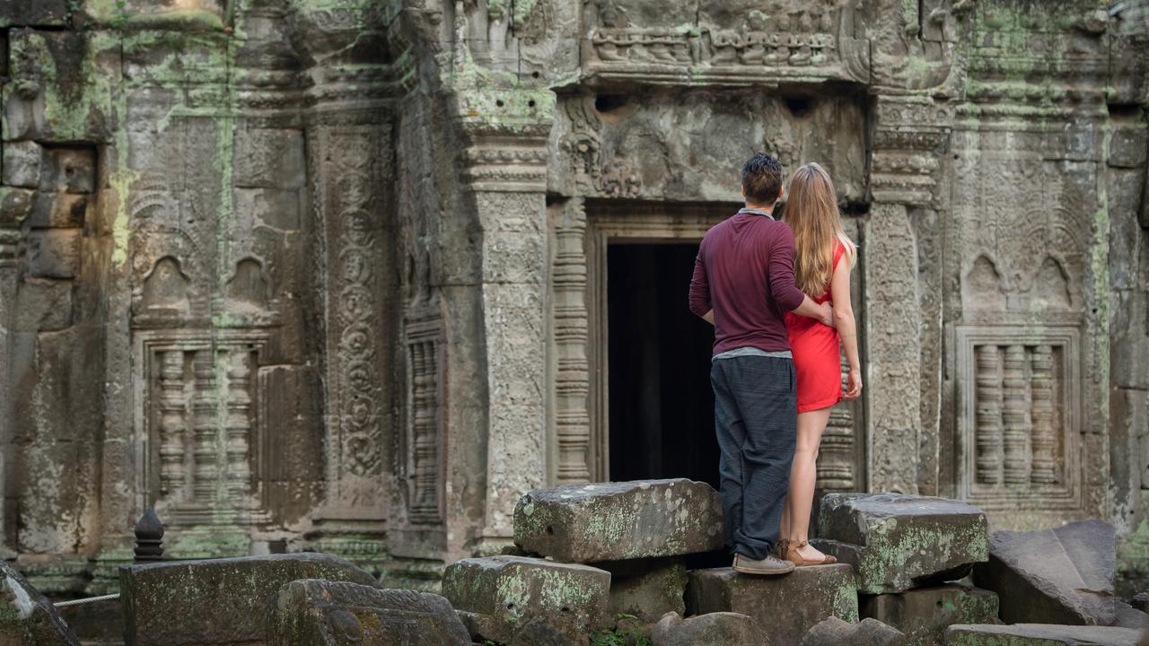 Couple exploring a remote temple in Cambodia