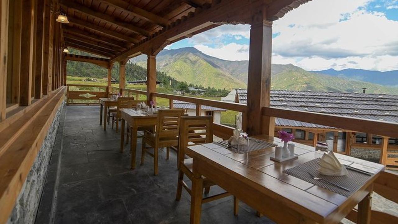 Tables set for dinner on a sheltered terrace