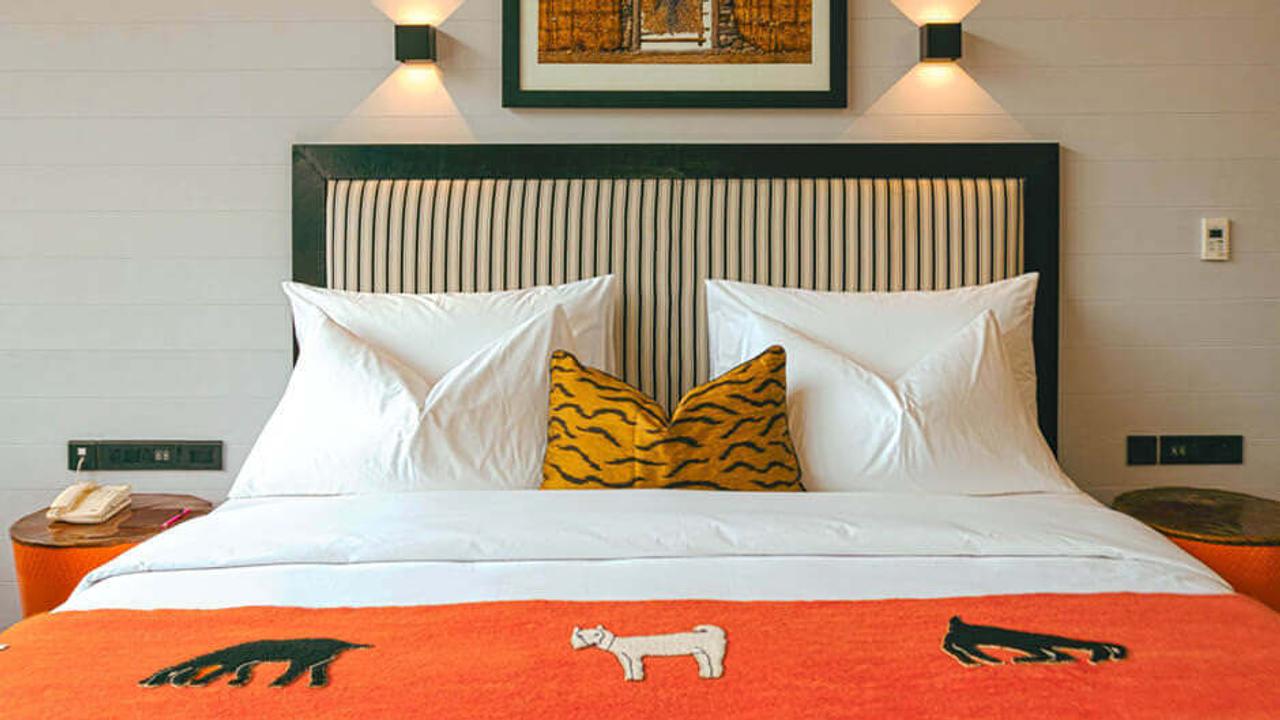 Double bedroom with bright orange design details