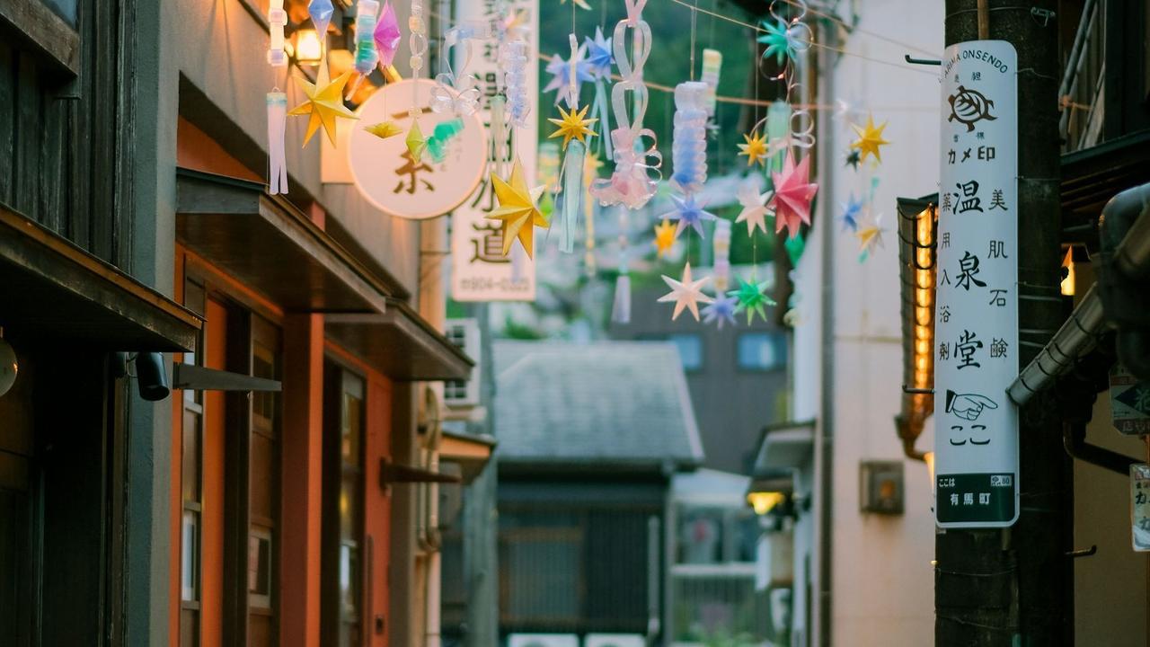 Coloured shop lights and star decorations in a street in an onsen town in Japan. Selective Asia.