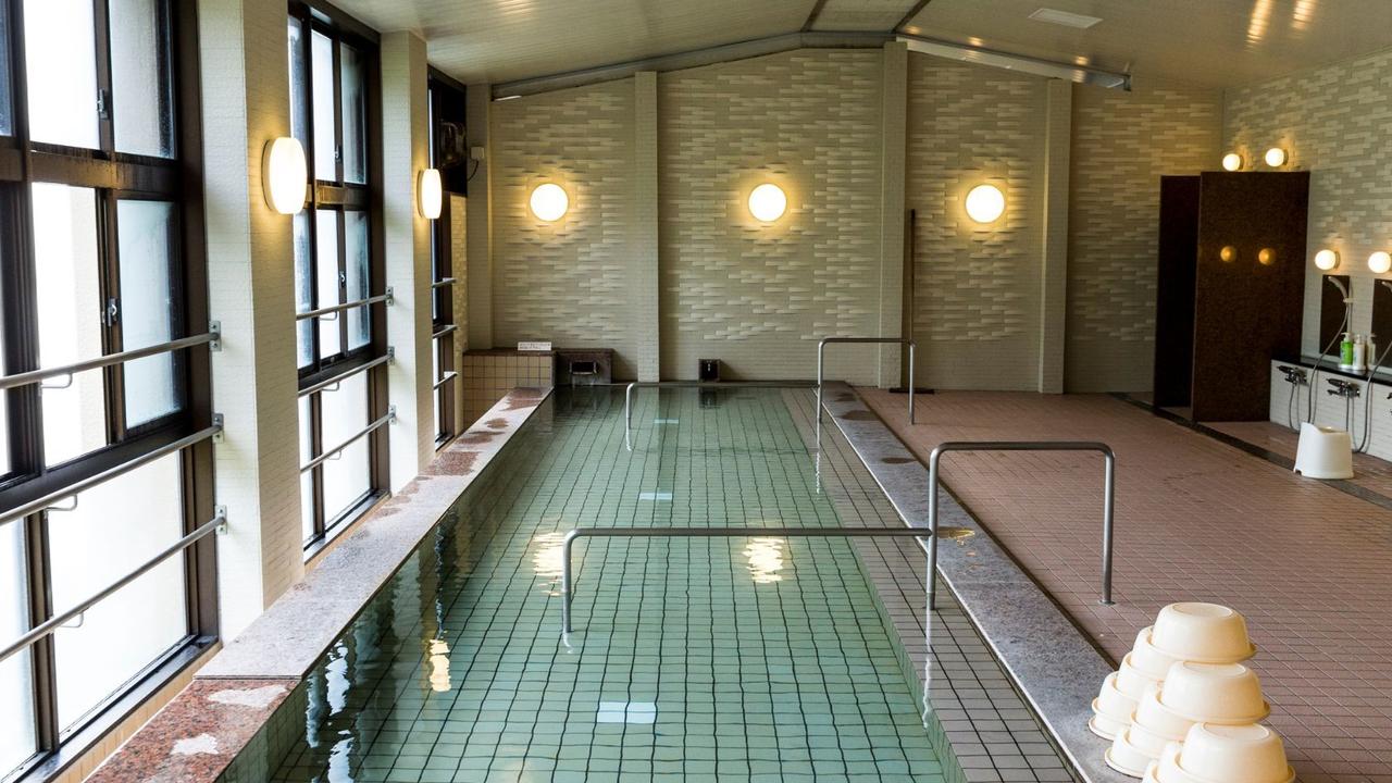 Indoor communal hit spring bath in Japan. Selective Asia.