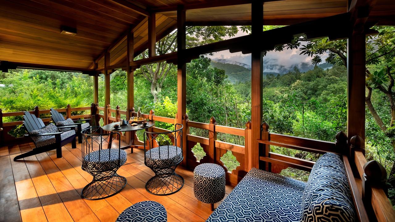 Sofas on a sheltered terrace with forest views at and Beyond Punakha River Lodge