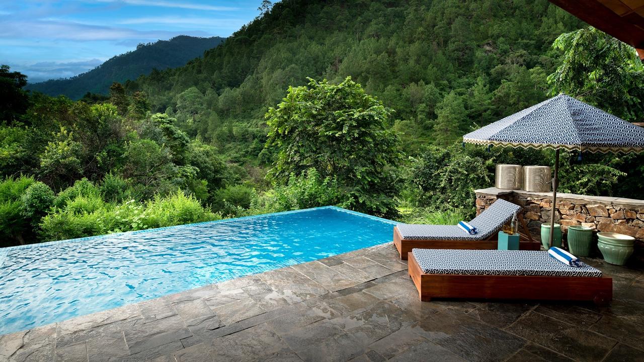 Loungers by the pool at and Beyond Punakha River Lodge