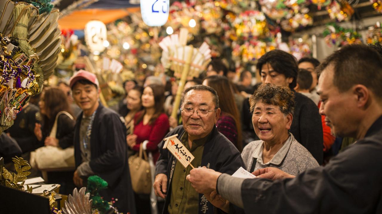 Customers at a stall at Torinoichi festival Shinjuku Tokyo Japan