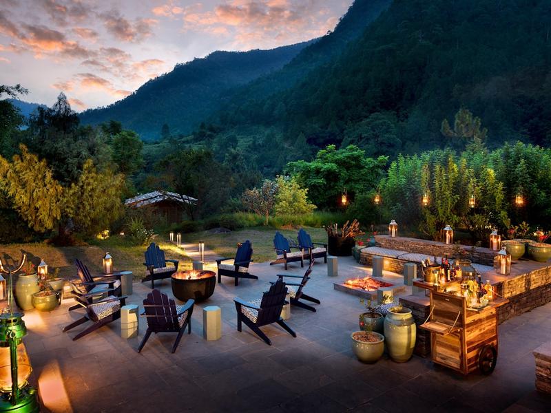 Loungers overlooking an infinity pool at and Beyond Punakha River Lodge